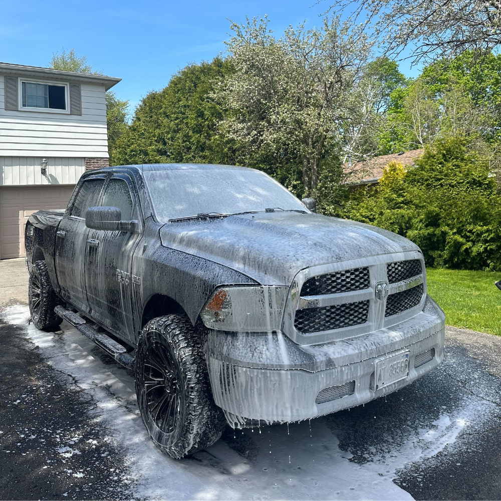 A truck that has soap covering it during an exterior detail