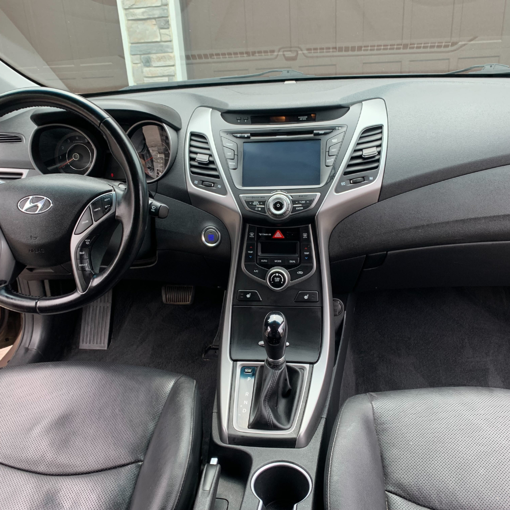 The interior dashboard of a sedan that was just detailed.